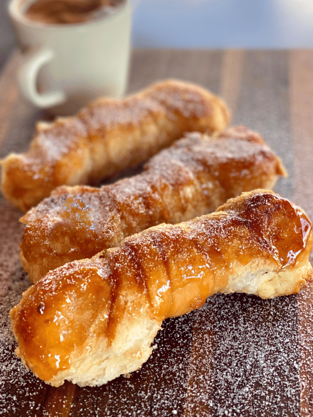 Caramelized quesitos cooling, sugar crust glistening